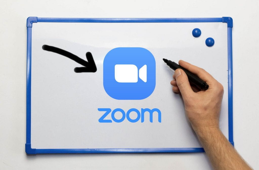 Whiteboard with a Zoom logo and a hand holding a marker